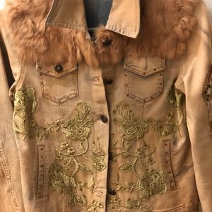 Embroidered jean jacket with fur trim.